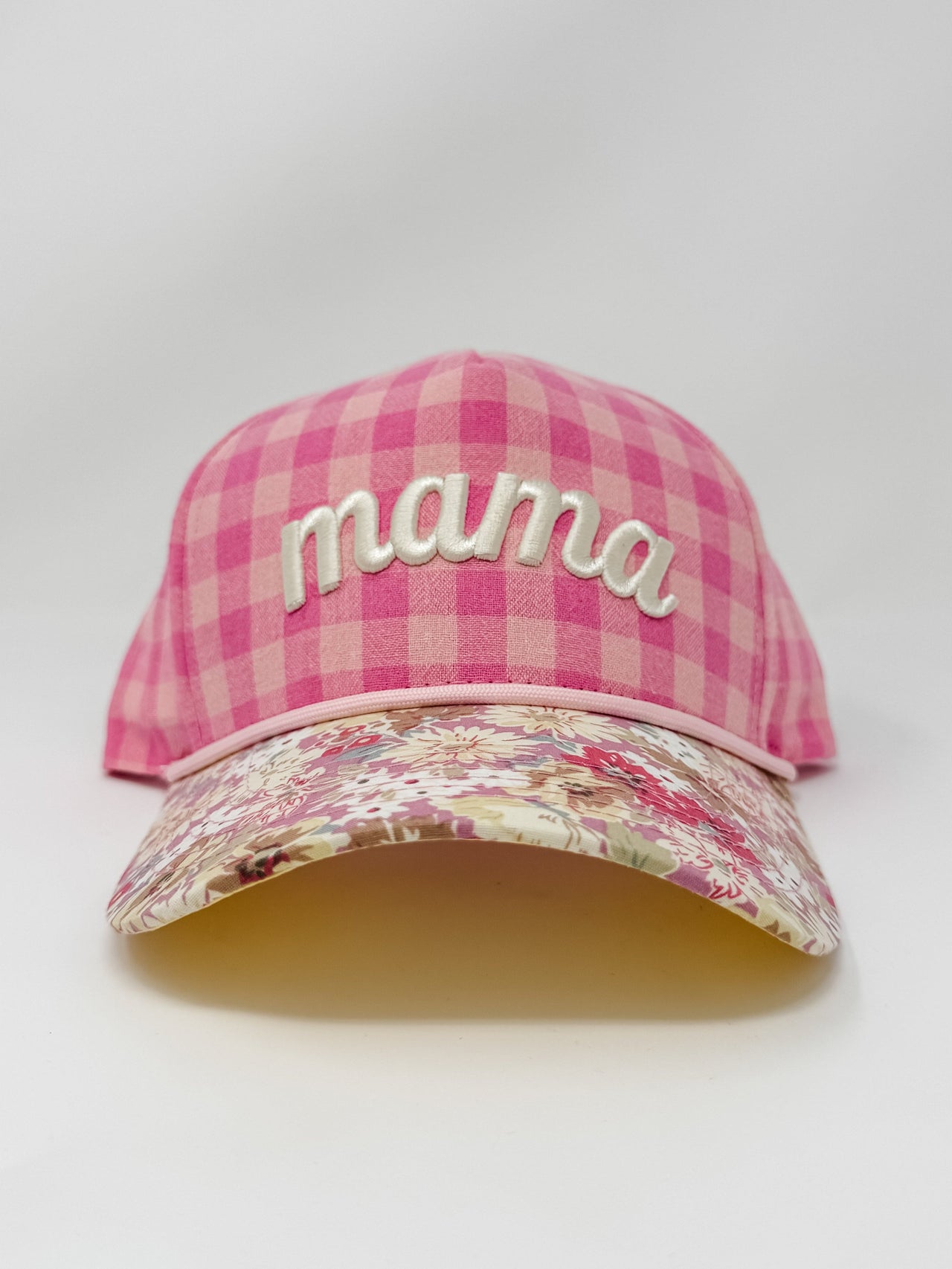 Pink plaid cap with floral brim and 'mama' embroidery on a white background