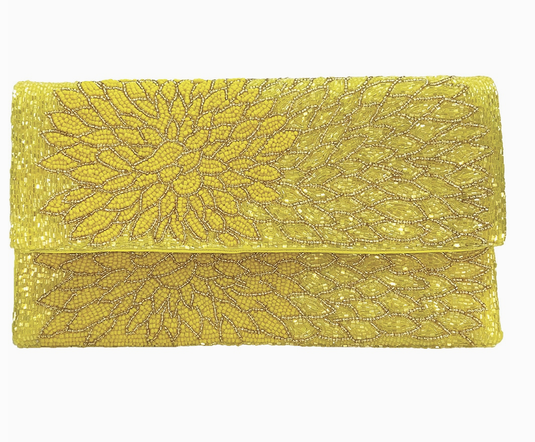 Yellow clutch beaded bag with intricate beaded design on a white background