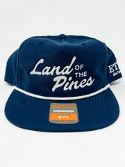 Navy blue cap with 'Land of the Pines' text on a white background