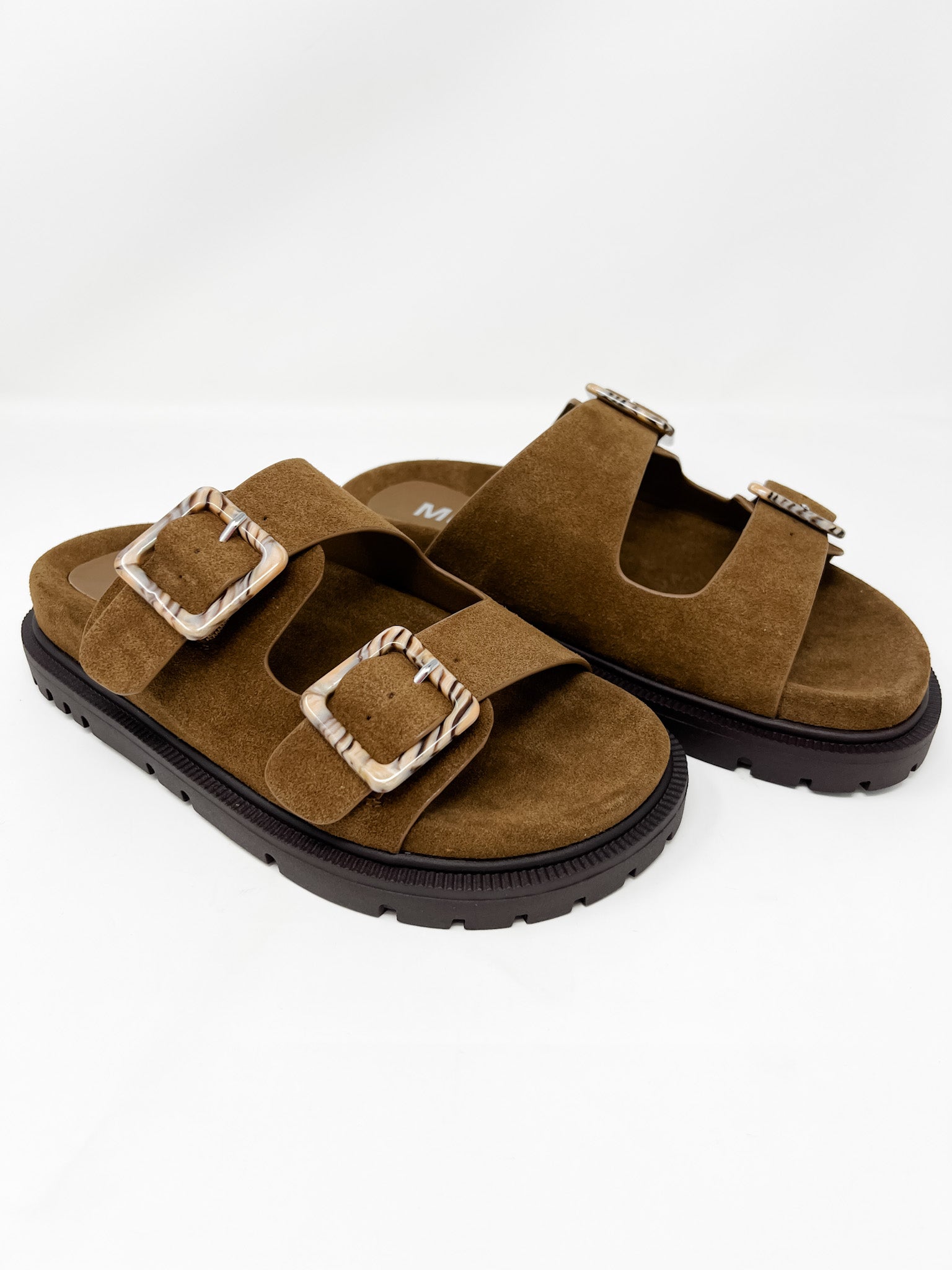 Brown sandals with buckles on a white background