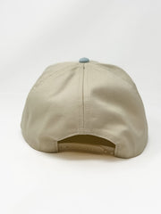 Cream and light blue two-tone baseball cap with raised “faithful” embroidery on the front.