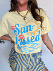 Woman wearing a graphic tee "Sun-kissed" with striped shorts