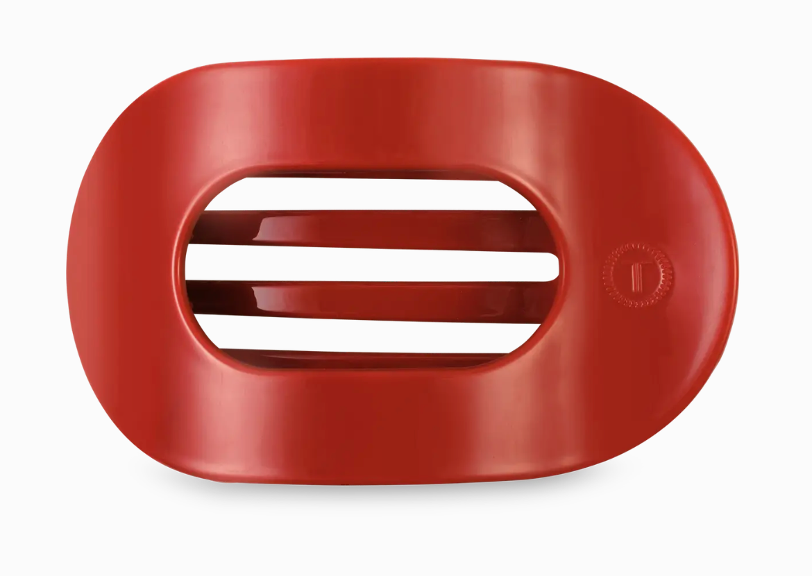 Red hair clip on a white background