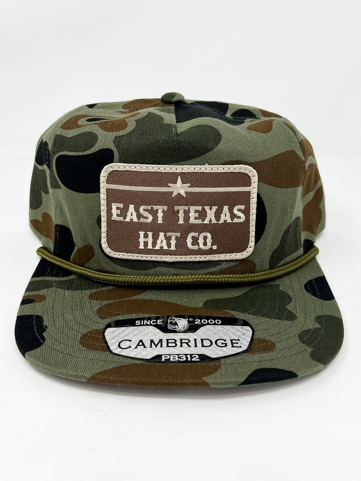 Camouflage cap with 'East Texas Hat Co.' and 'Cambridge' branding on a white background