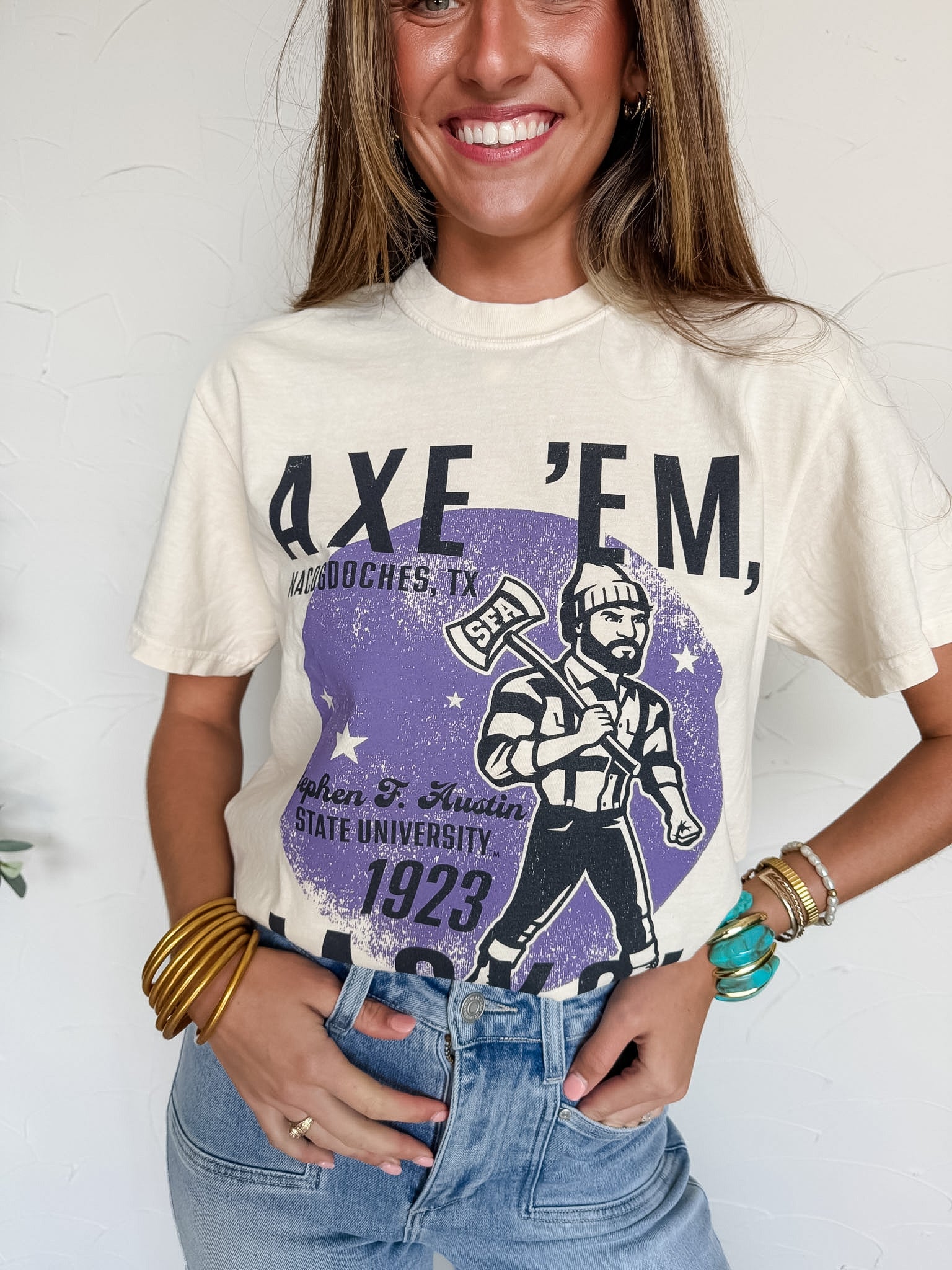 Person wearing a t-shirt with graphic SFA "Axe'em" design and text