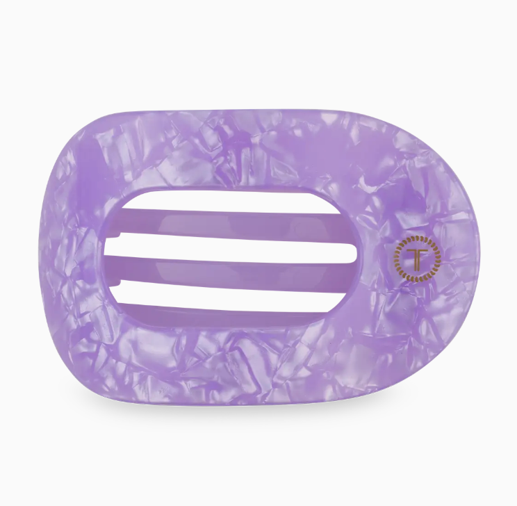 Purple marbled hair clip with a brand logo on a white background