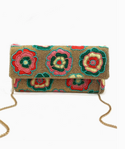 Floral patterned beaded clutch bag with chain strap on a white background