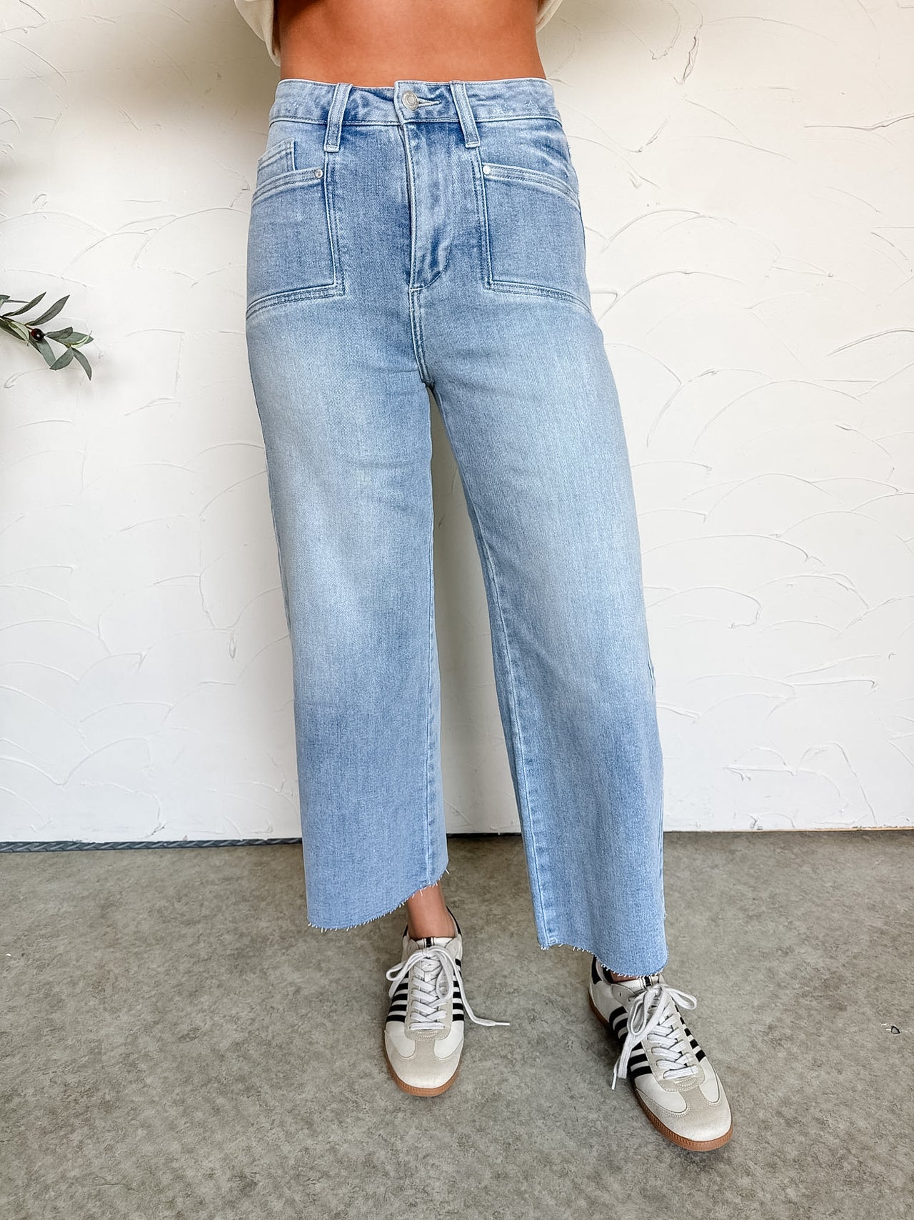Light blue jeans worn by a person on a neutral background