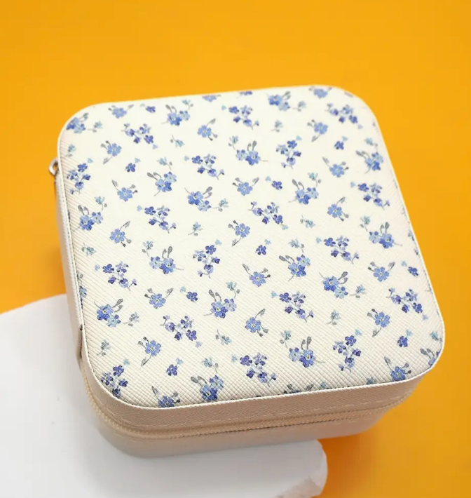 Floral-patterned pouch on a yellow background