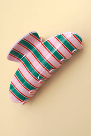 Striped candy cane-shaped object on a beige background
