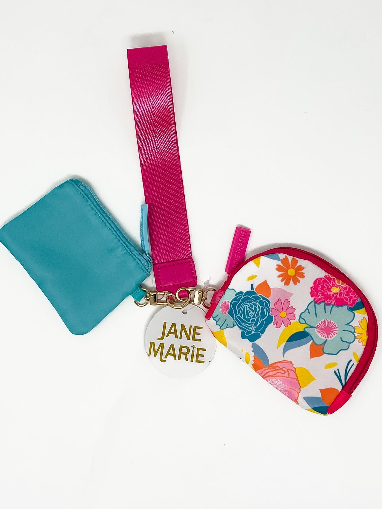 A pink and blue wristlet with two zipper pouches, one with a multi color floral pattern.