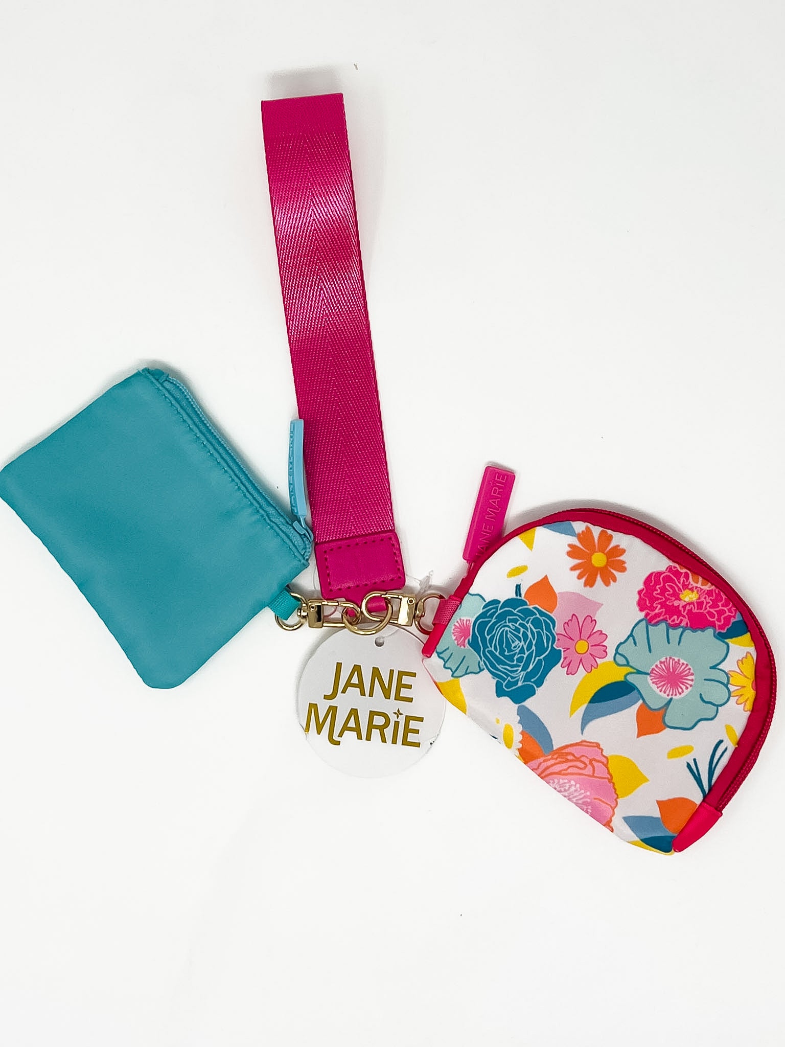 A pink and blue wristlet with two zipper pouches, one with a multi color floral pattern.