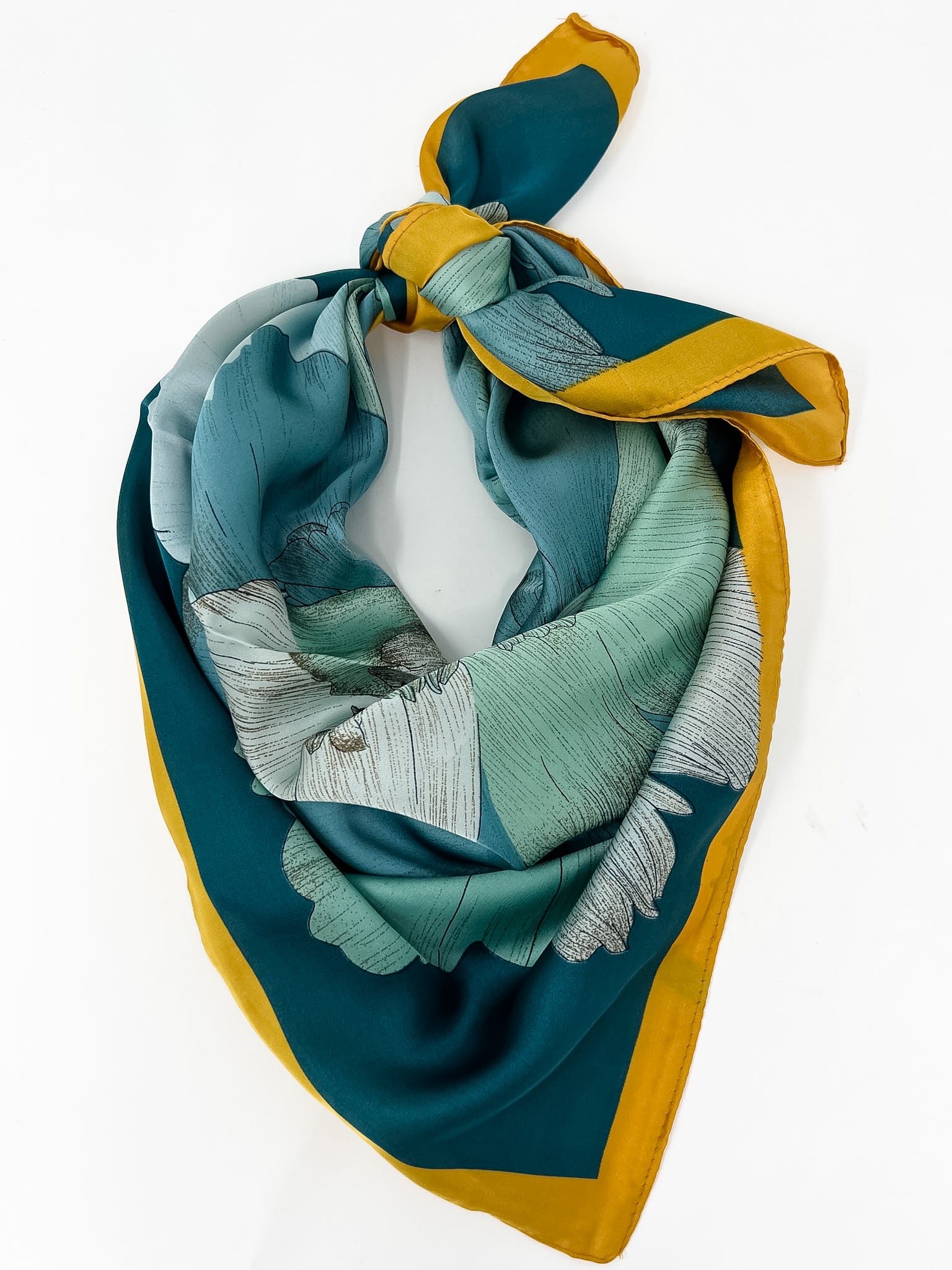 teal, blue and yellow silk scarf on a white background