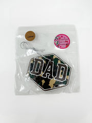 Camouflage 'DAD' car air freshener in clear packaging with a label on a white background