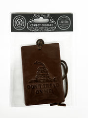 Brown leather air freshener with 'Don't Tread on Me' design and leather goods packaging above.