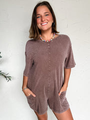 women wearing a brown shorts sleeve/short romper with pockets