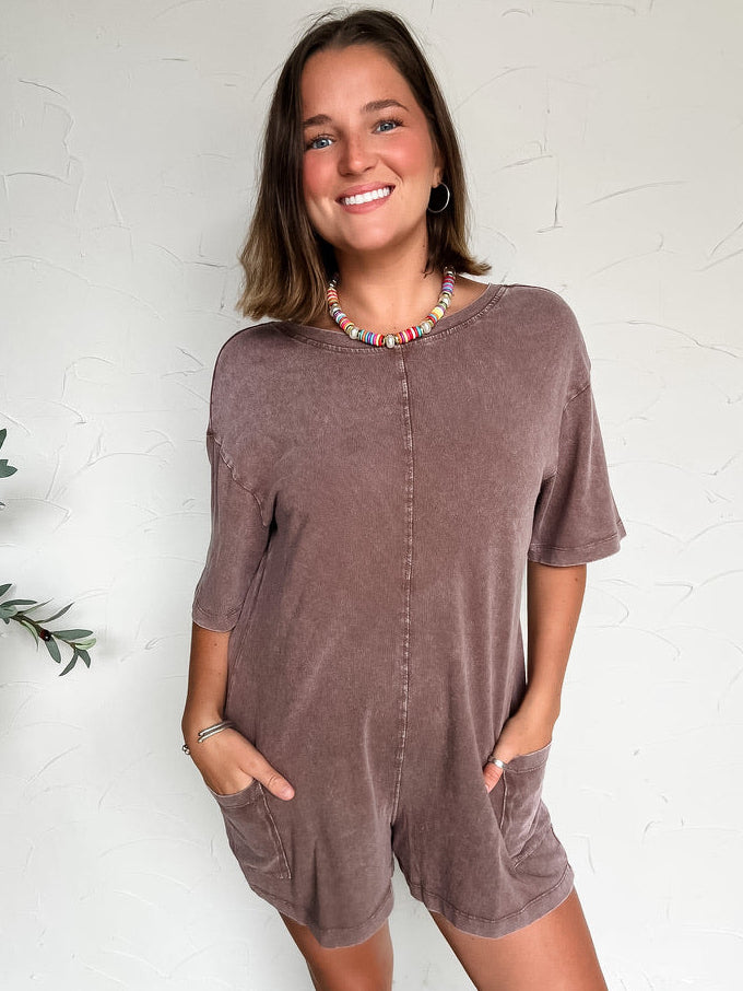 women wearing a brown shorts sleeve/short romper with pockets