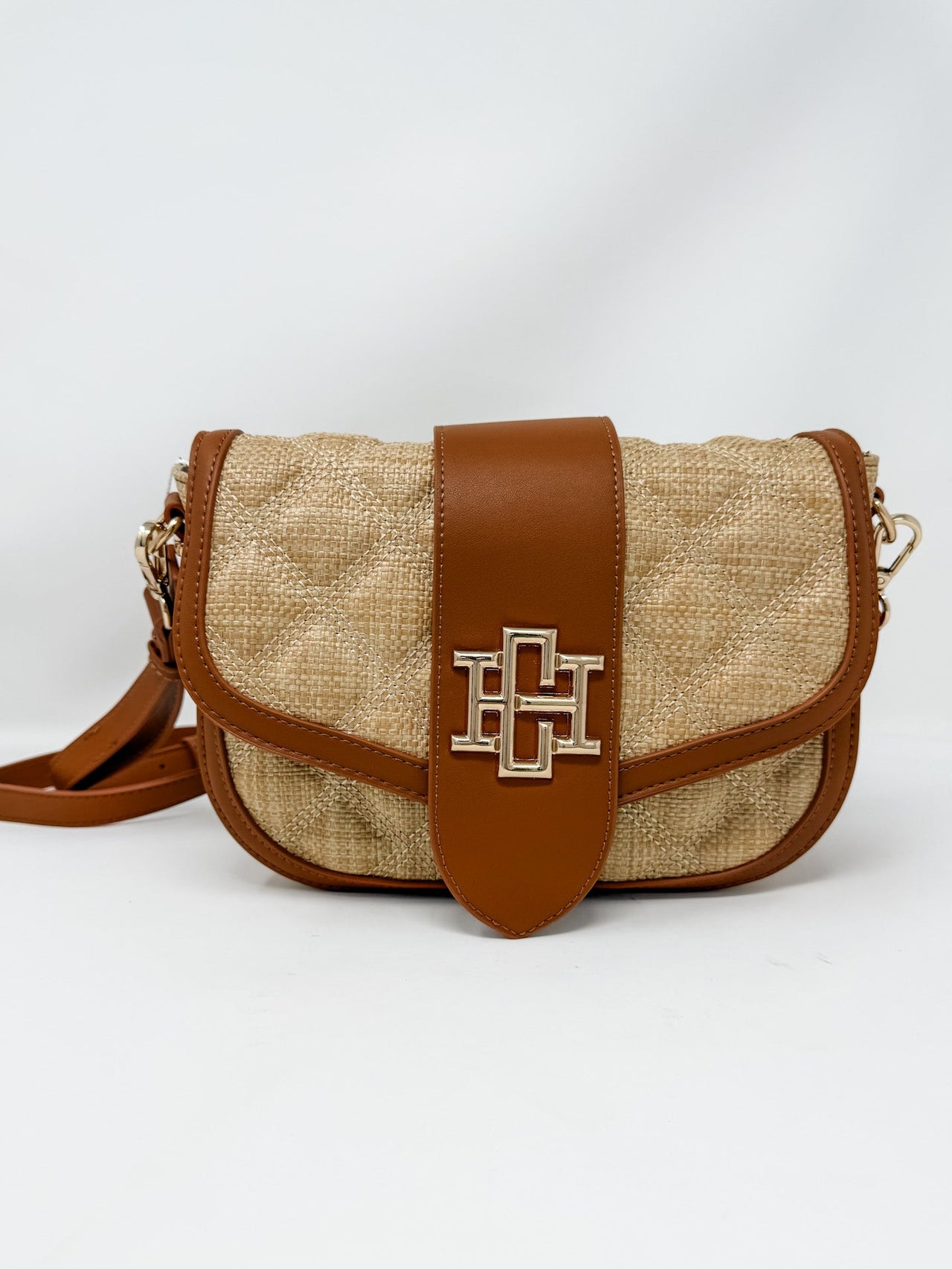 Beige and brown handbag with a logo on a white background