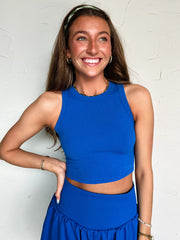 Woman wearing a blue outfit against a white background