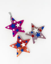 Star-shaped ornaments in red, blue, and purple on a white background