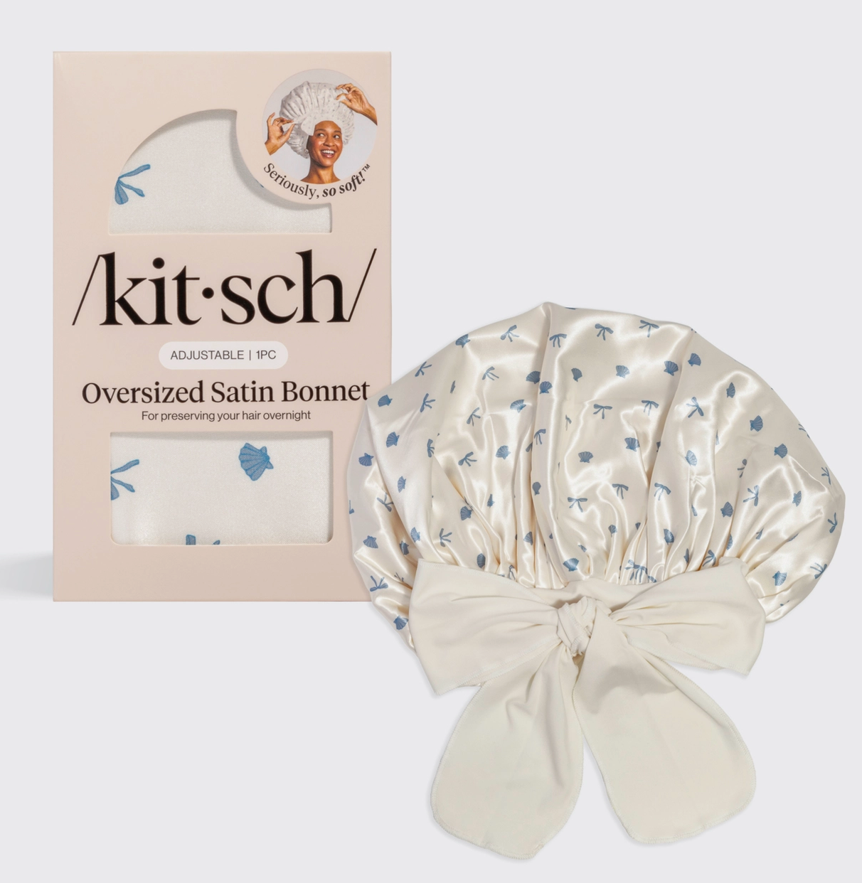 Kit-sch oversized satin bonnet patterned with shells and bows with packaging on a white background
