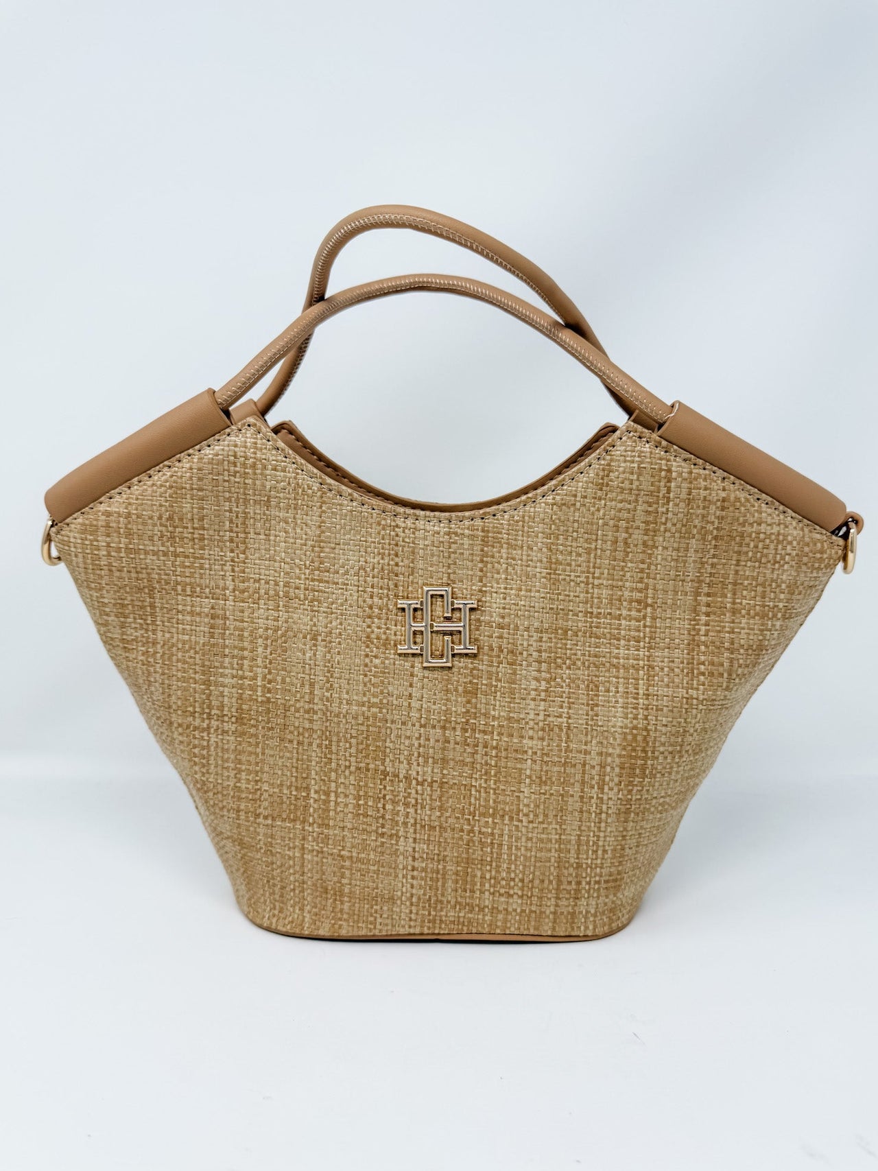 Woven handbag with brown handle and logo on a white background