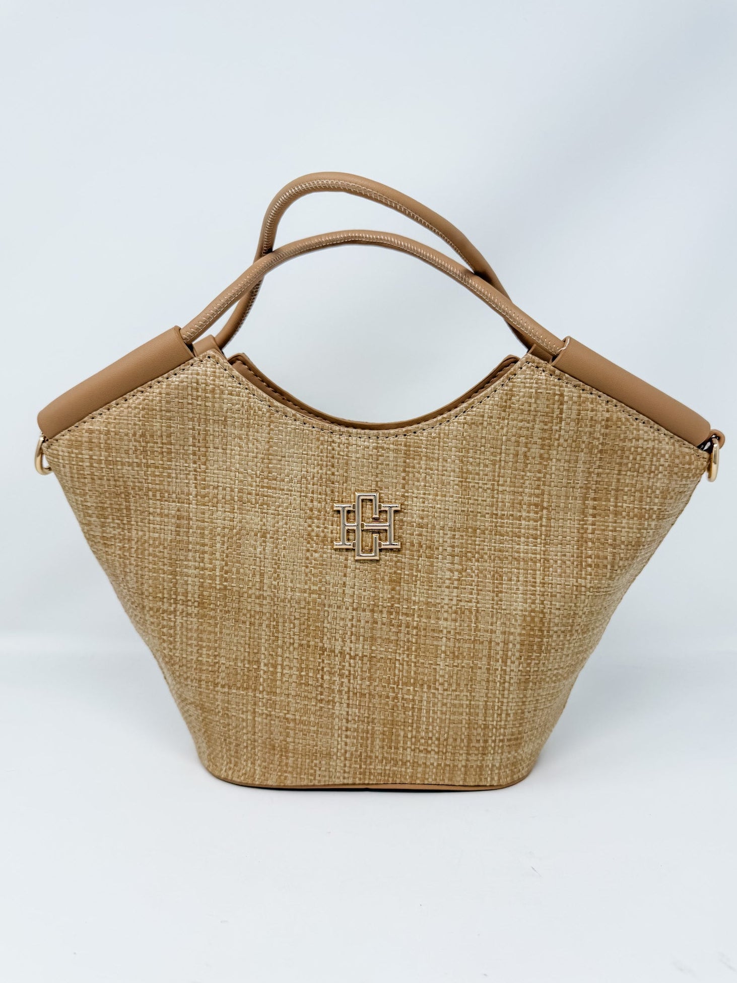 Woven handbag with brown handle and logo on a white background