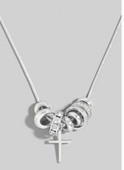 Silver necklace with interlocking rings and a cross pendant on a light gray background
