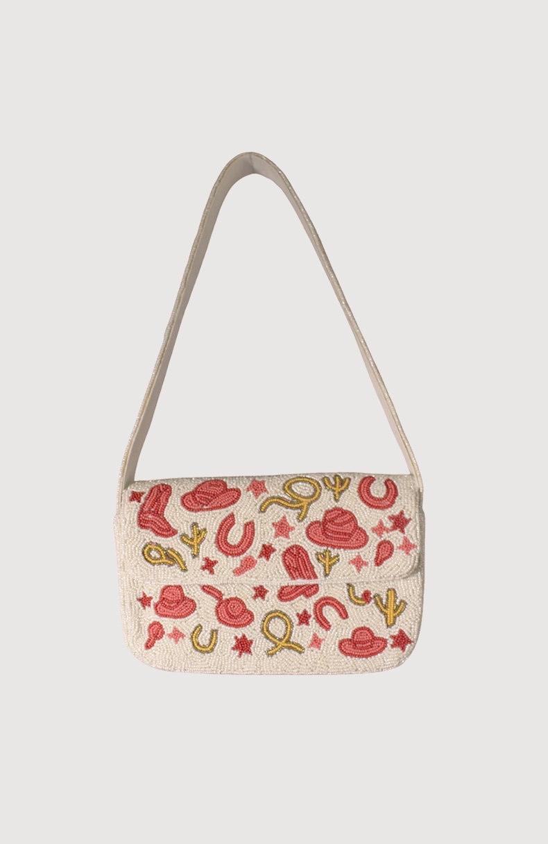 Small beaded handbag with cowboy-themed pattern on a light background