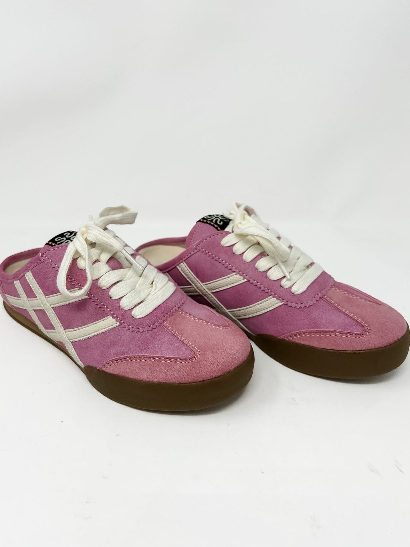 Pink slide on sneakers with white laces on a white background