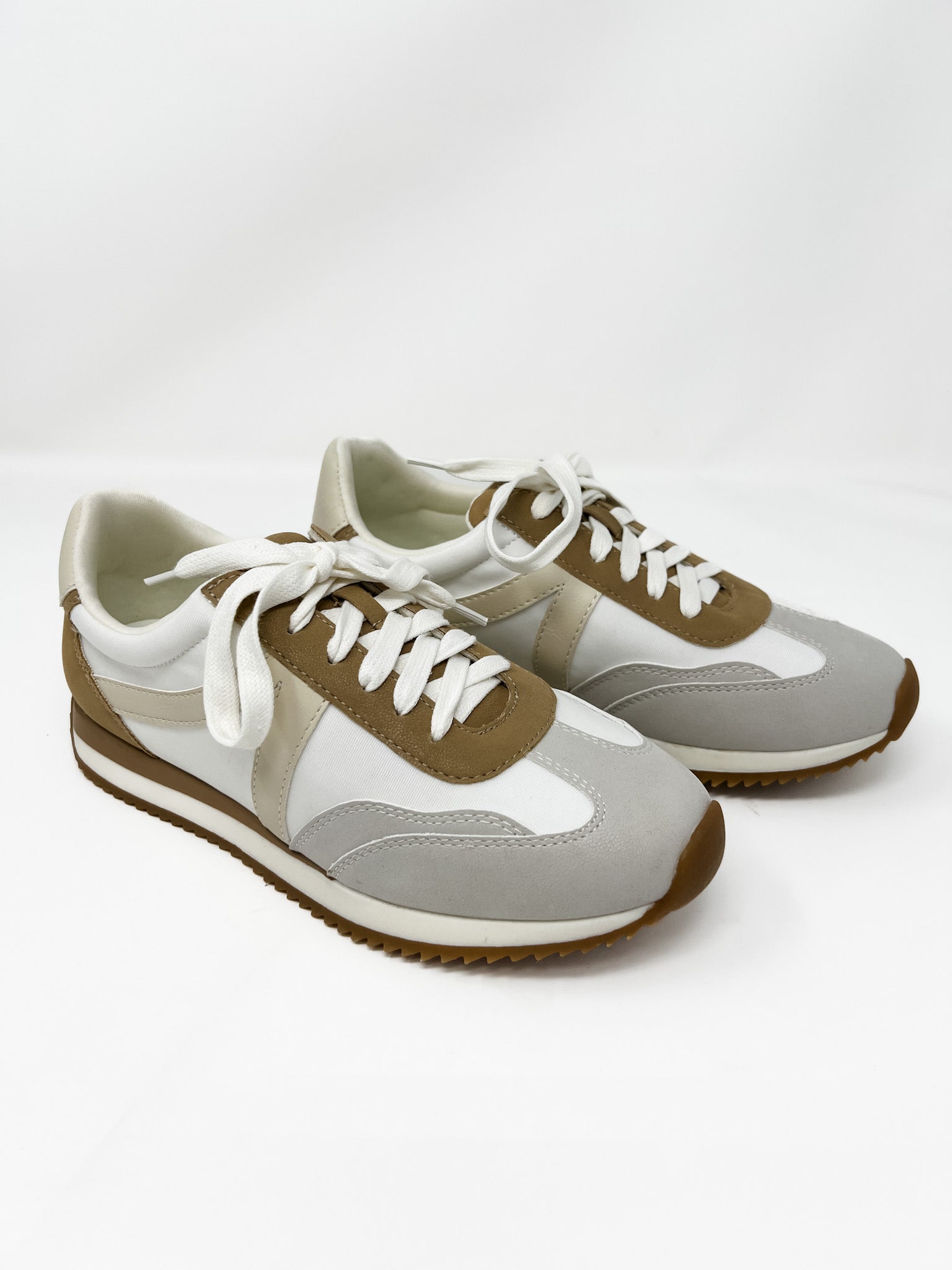 Pair of gray and brown sneakers on a white background