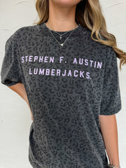 Person wearing a gray t-shirt with 'Stephen F. Austin Lumberjacks' text against a white background