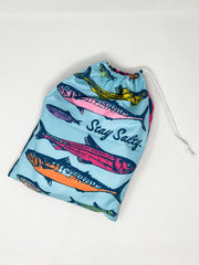Drawstring bag with fish design and 'Stay Salty' text on a light blue background