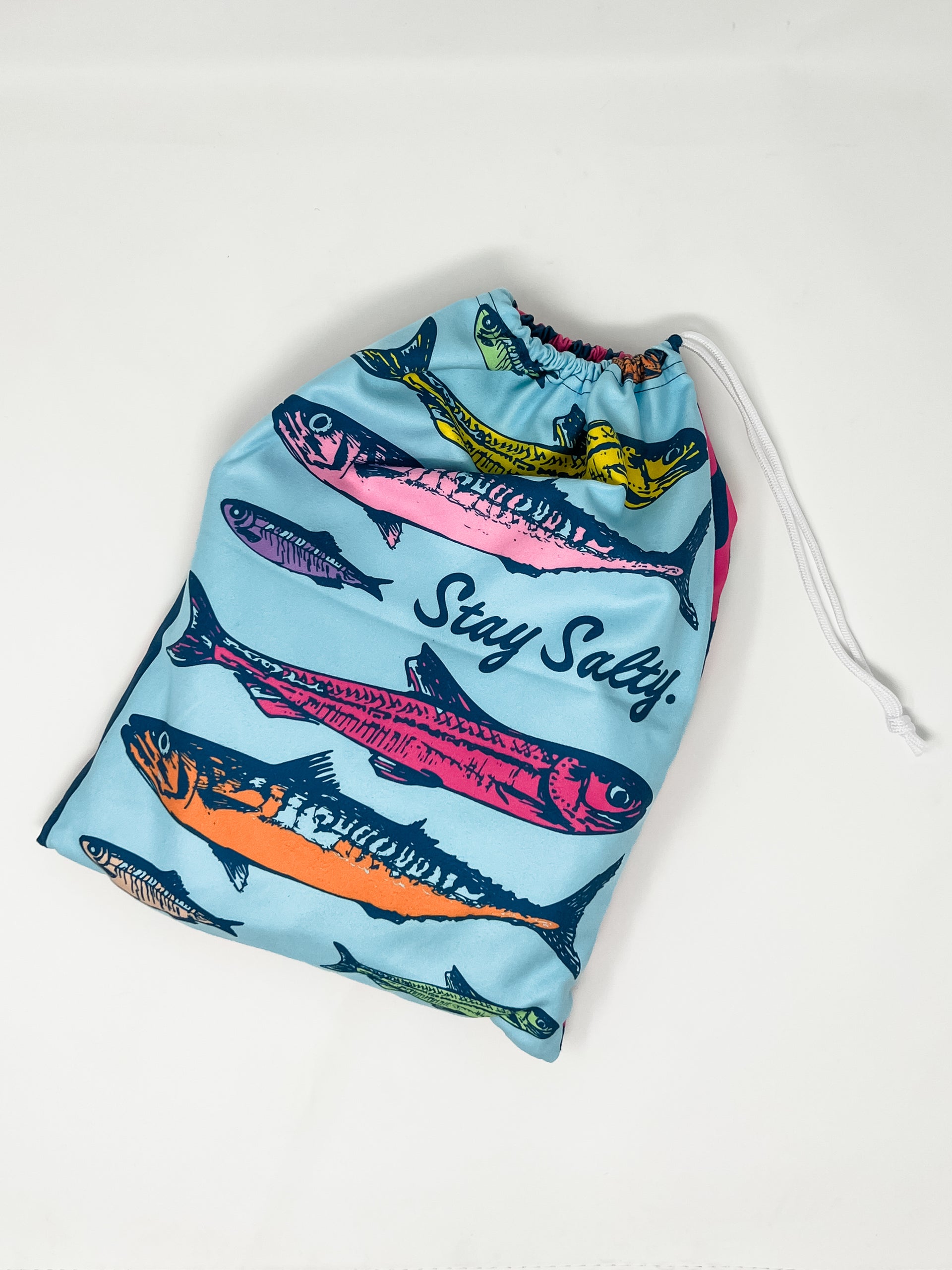 Drawstring bag with fish design and 'Stay Salty' text on a light blue background