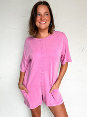 women wearing a pink shorts sleeve/short romper with pockets