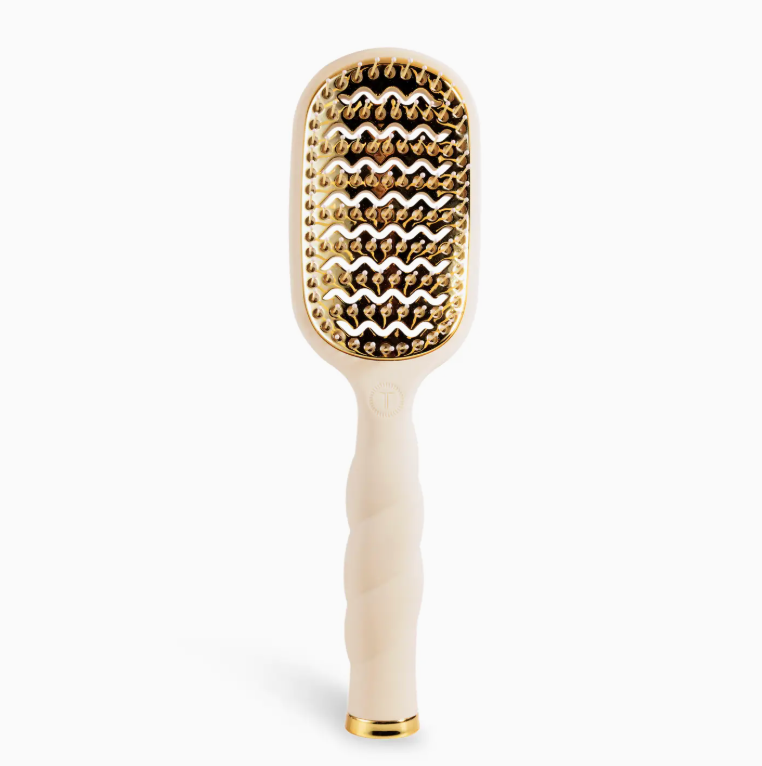 Beige and gold hairbrush on a white background