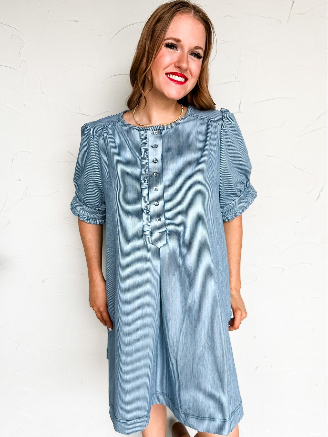 Woman wearing a blue dress with a white background