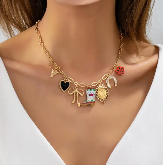 Necklace with various charms on a mannequin with a white background