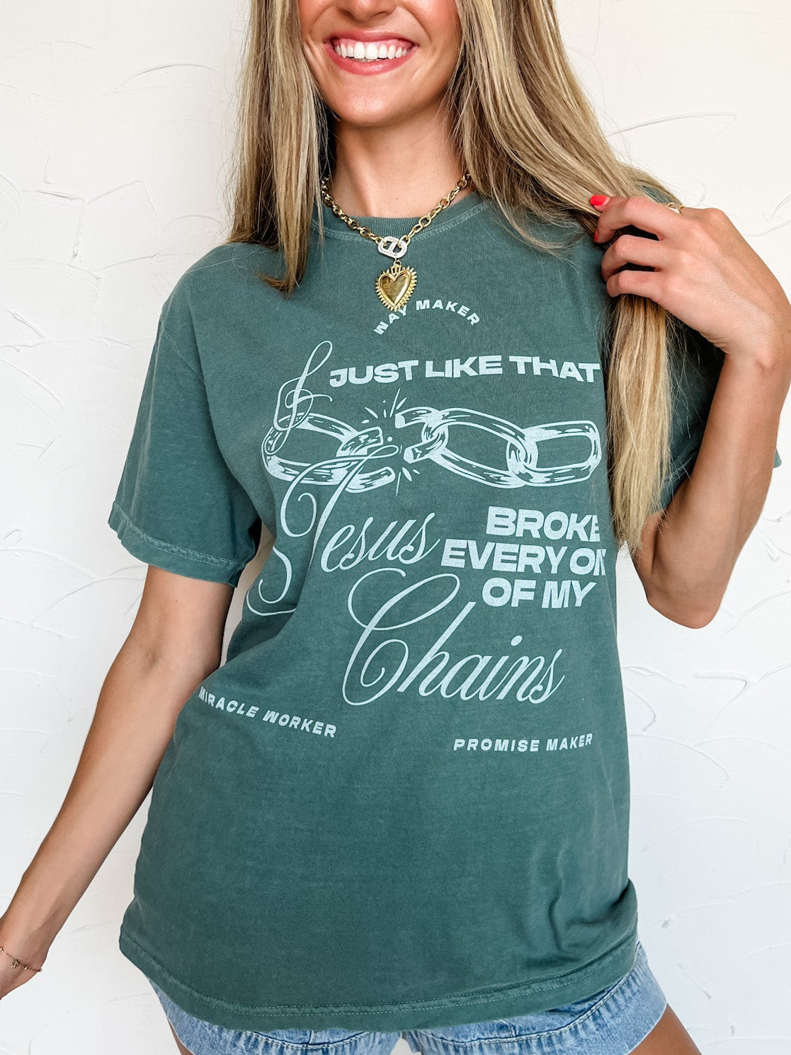 Woman wearing a green t-shirt with text and graphics on a white background