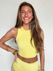 women wearing a yellow tank top and yellow shorts