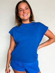 woman wearing a blue short sleeve and short matching outfit 