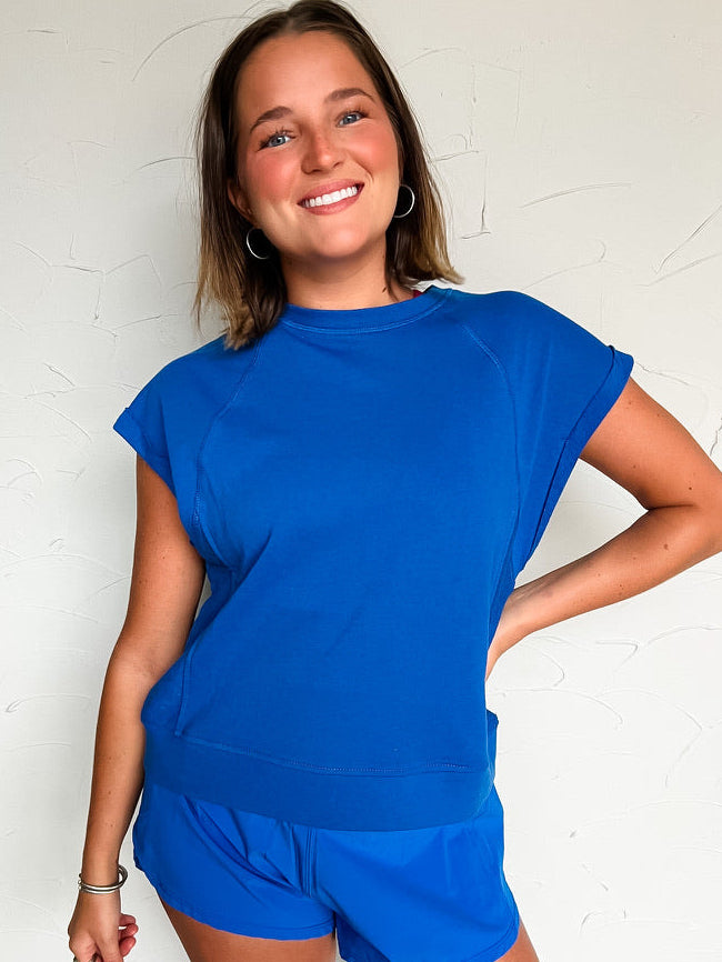 woman wearing a blue short sleeve and short matching outfit 
