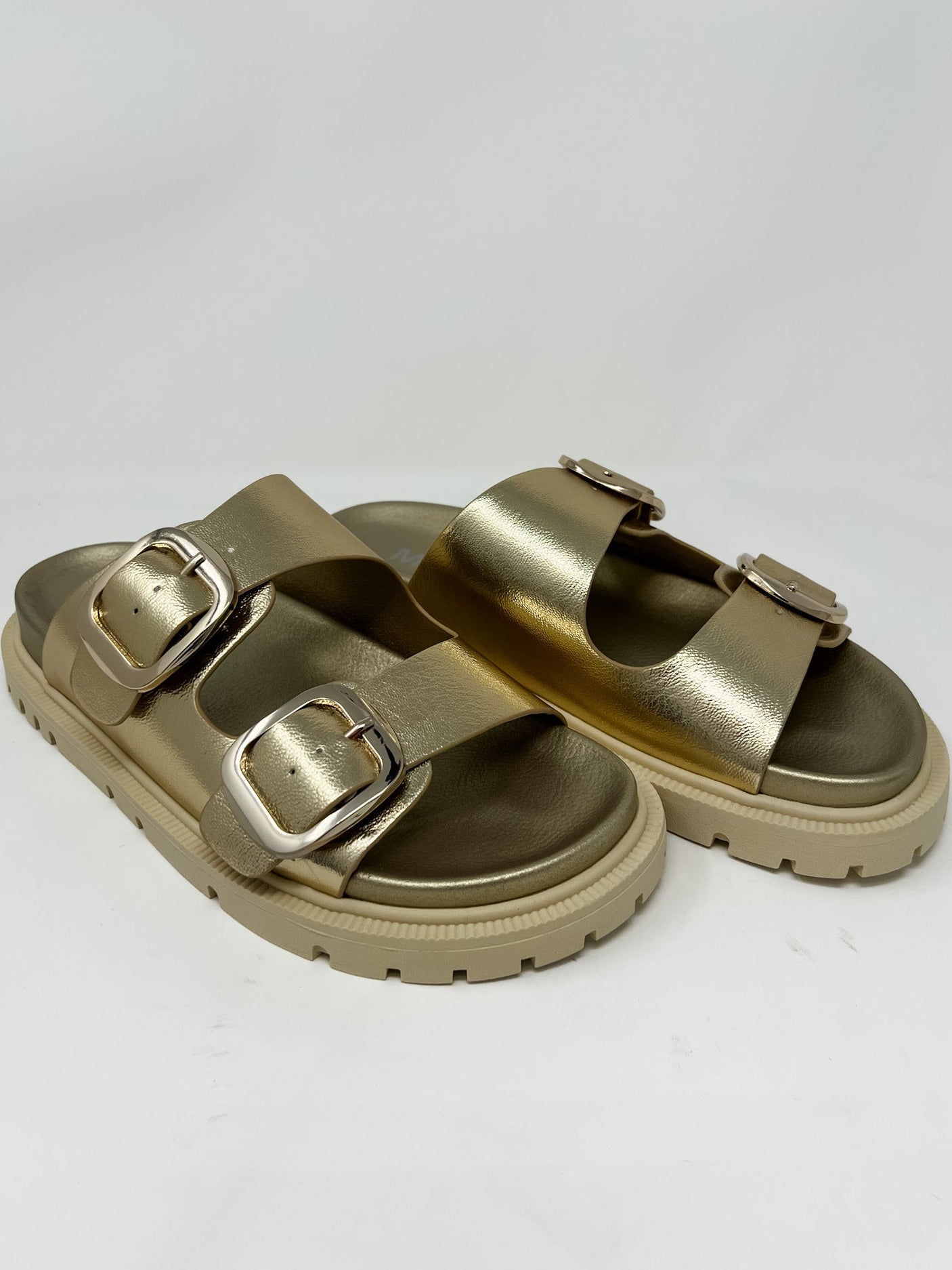 Gold sandals with buckles on a white background