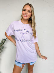 Woman wearing a Stephen F. Austin State University t-shirt against a white background