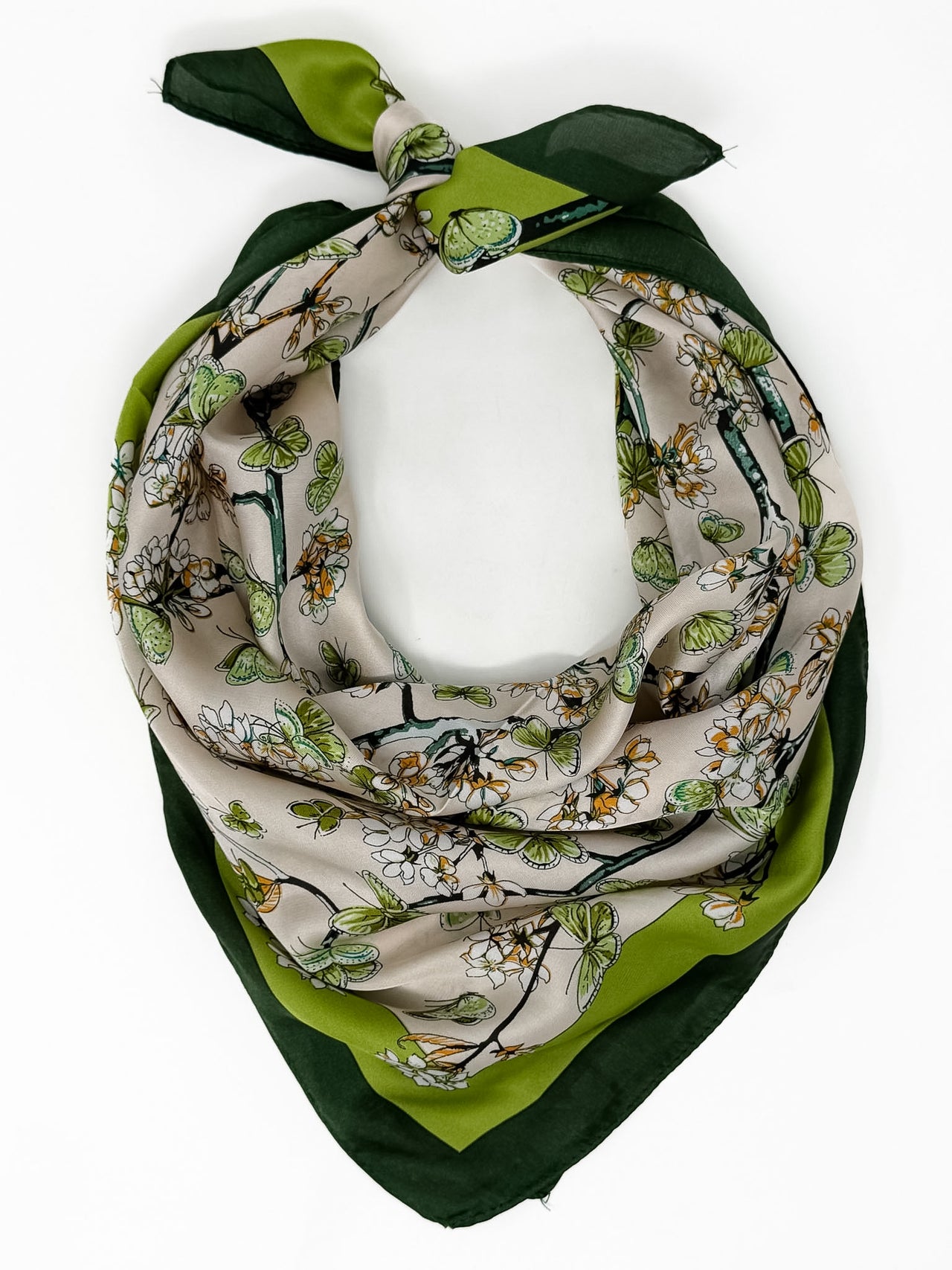 Floral patterned scarf with green accents on a white background