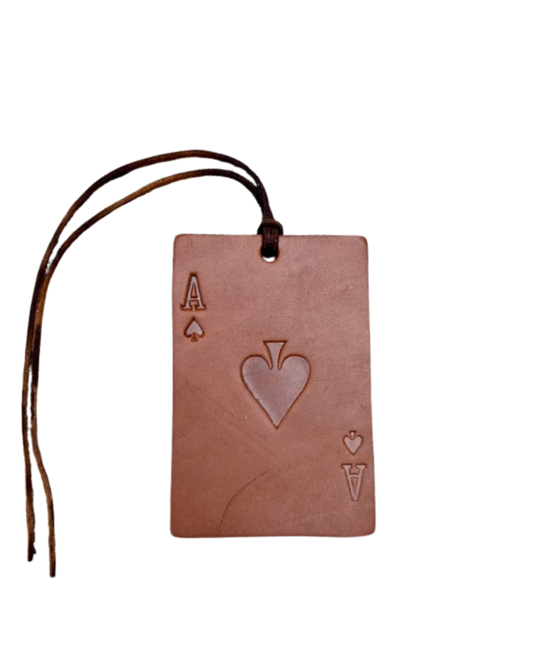 A rectangular leather card tag designed to look like an Ace of Spades playing card, featuring an embossed heart in the center and a dark brown leather hanging loop with frayed ends, shown on a plain white background.