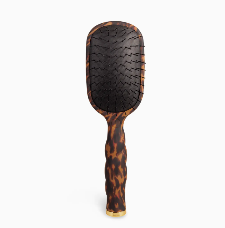Hairbrush with tortoiseshell pattern on a white background