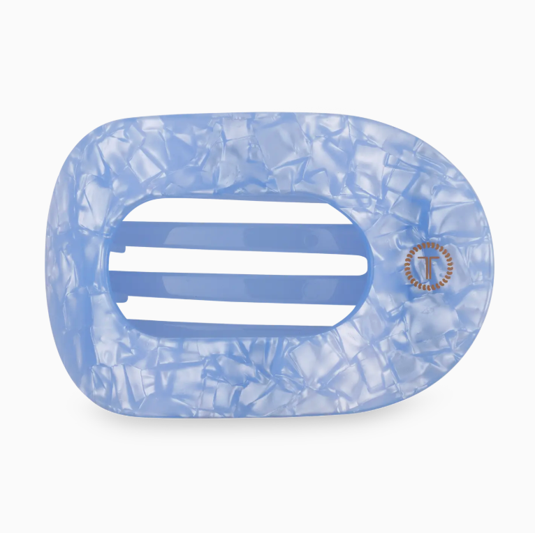 Blue and white marbled hair clip with a brand logo on a white background