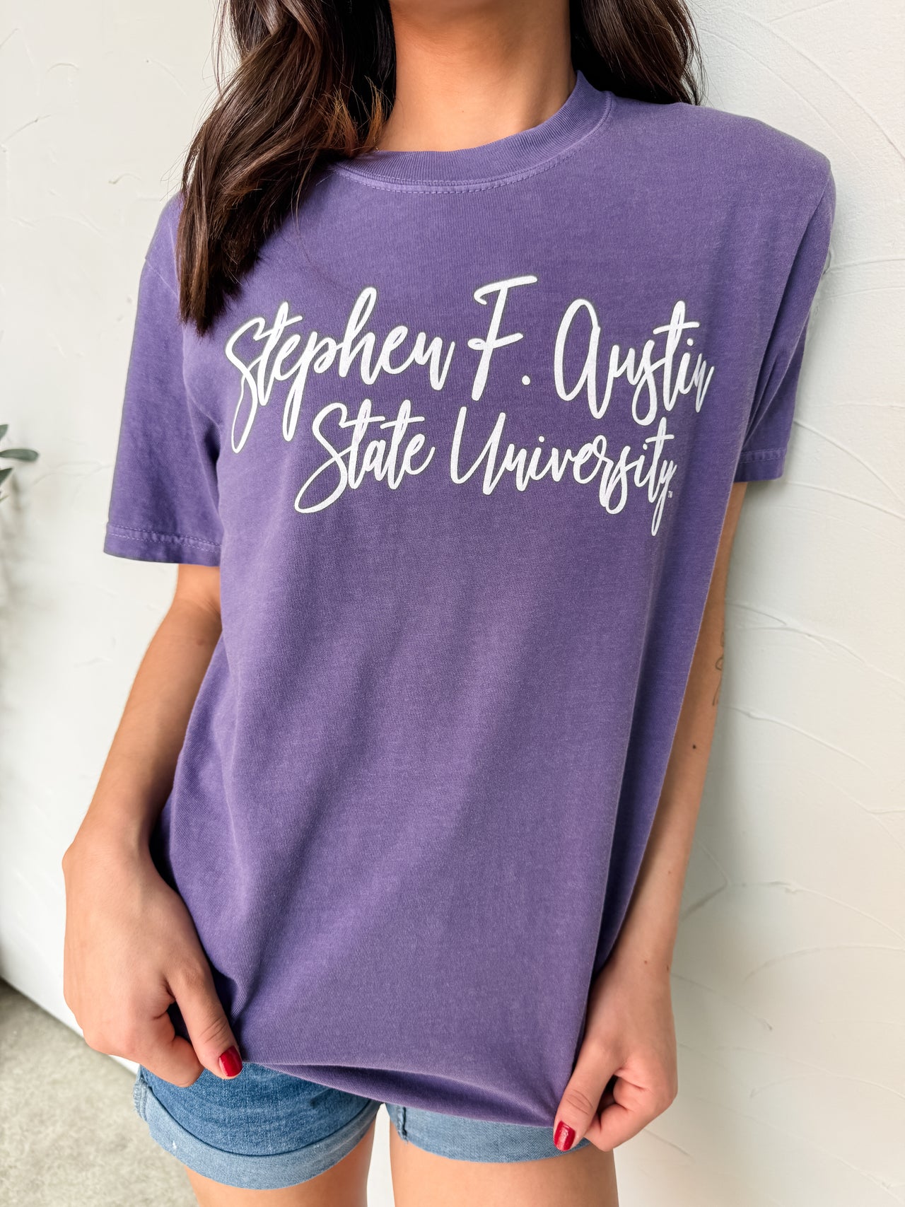 Person wearing a purple t-shirt with 'Stephen F. Austin State University' text.