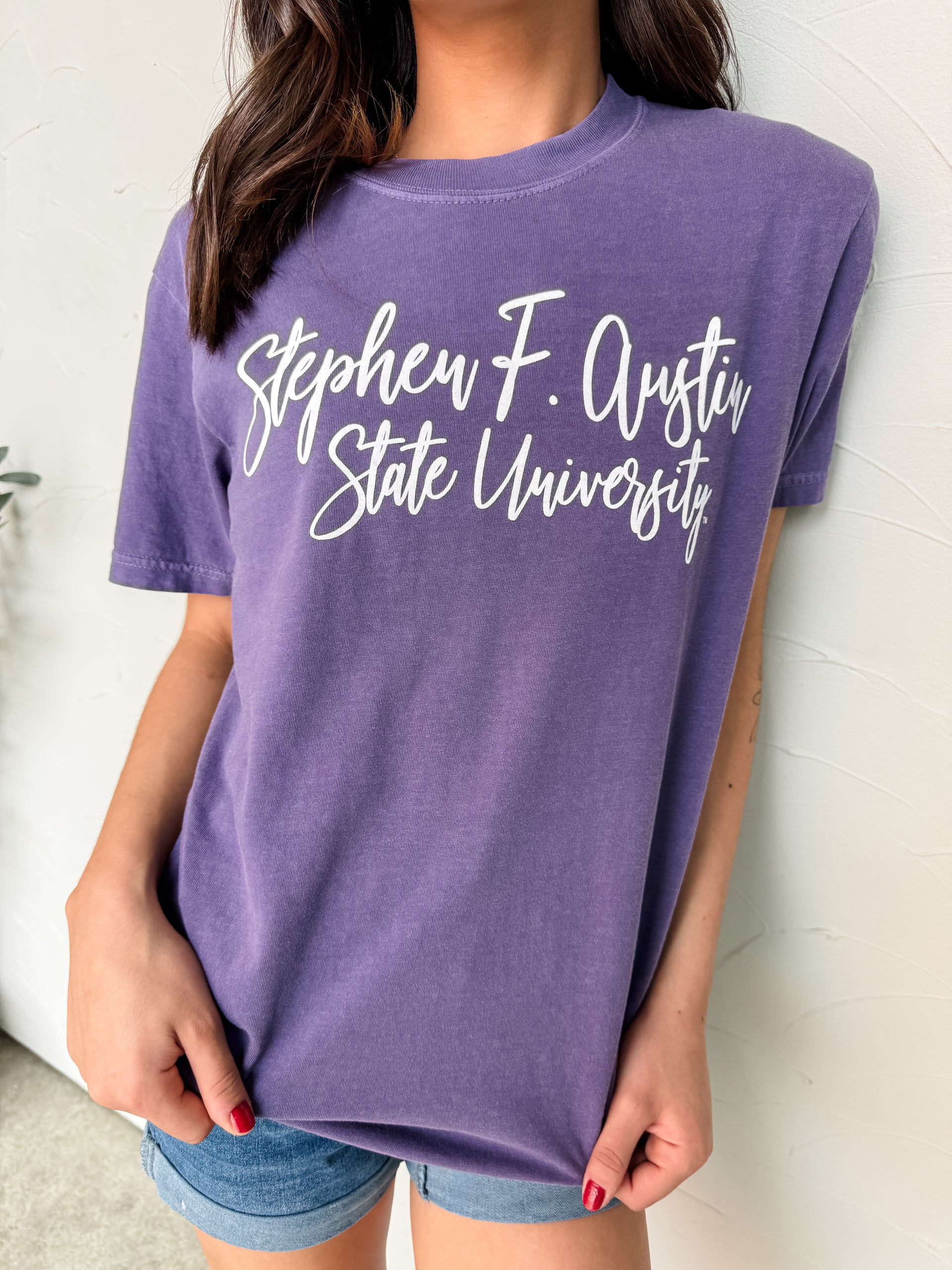 Person wearing a purple t-shirt with 'Stephen F. Austin State University' text.